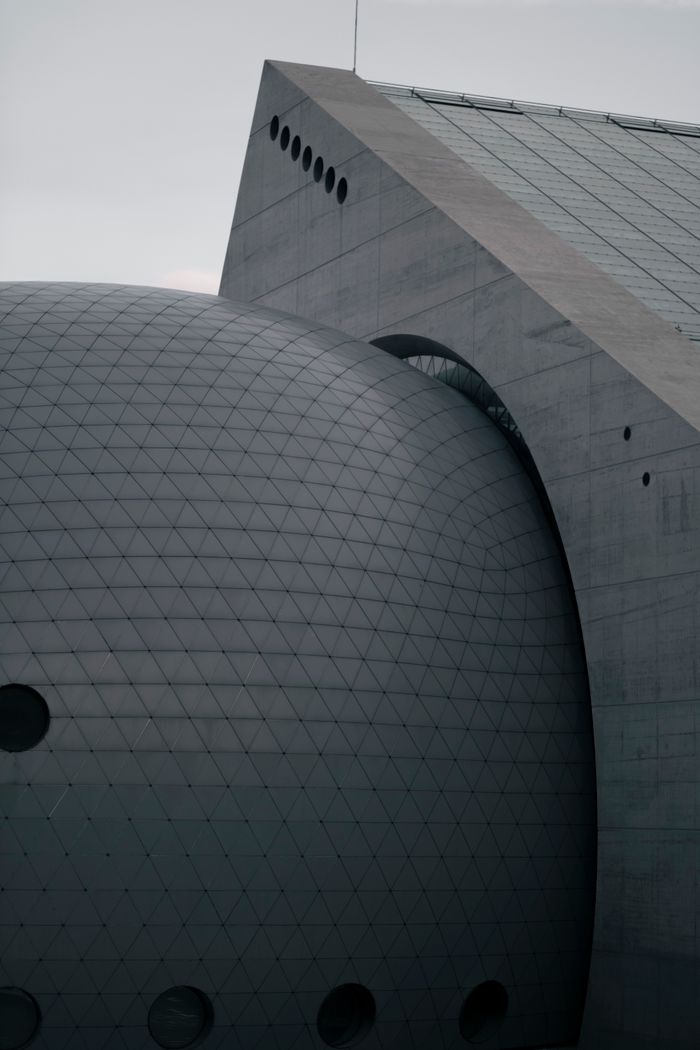 Close-up of a modern building with geometric patterns and unique architectural design.