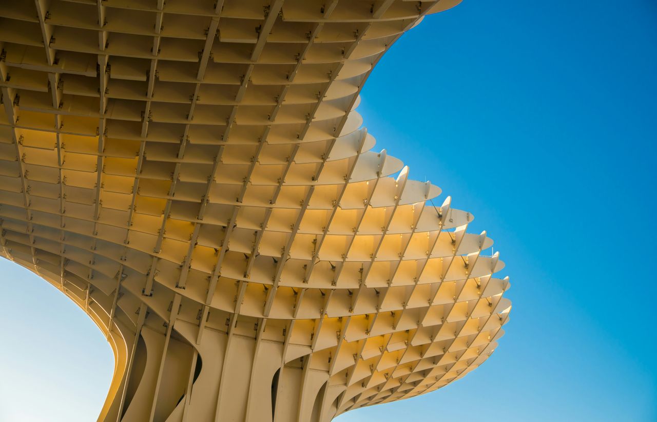 A visually striking modern architectural form with geometric design against a blue sky.