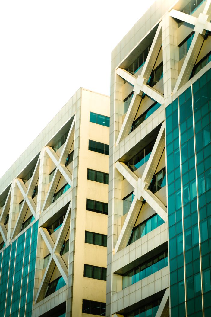 Close-up view of a modern building facade with geometric patterns and glass elements.