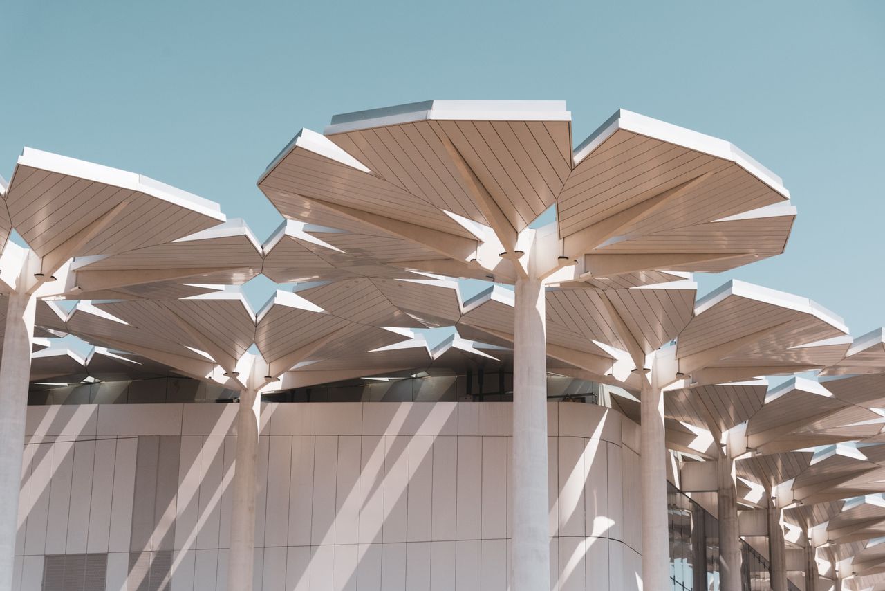Contemporary architecture featuring innovative geometric rooftop structures in bright sunlight.